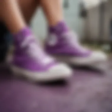 Person cleaning purple Converse shoes