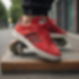 Vibrant red Adidas sneakers on a skateboard