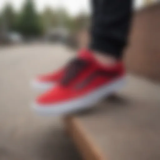 Stylish red and black Vans Old Skool sneakers on a skateboard