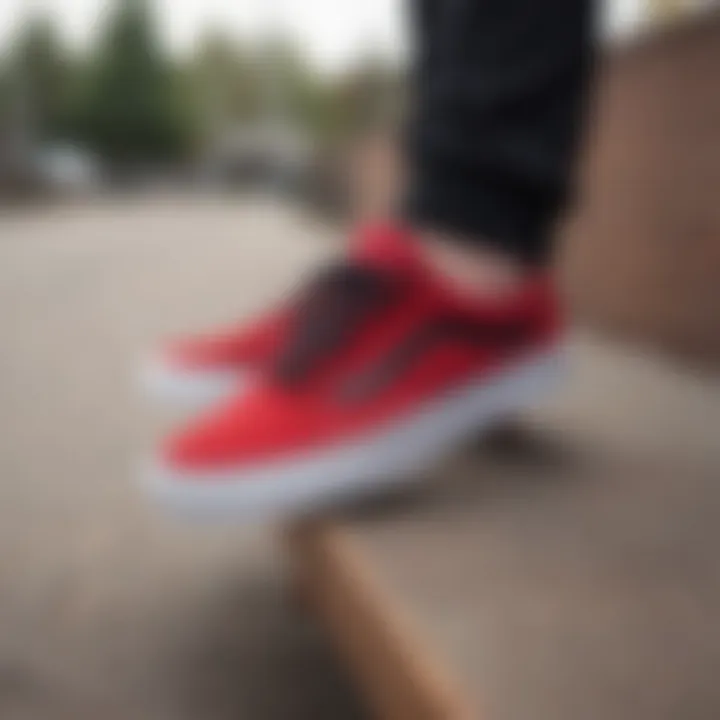 Stylish red and black Vans Old Skool sneakers on a skateboard