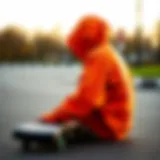 A dark orange hoodie draped over a skateboard