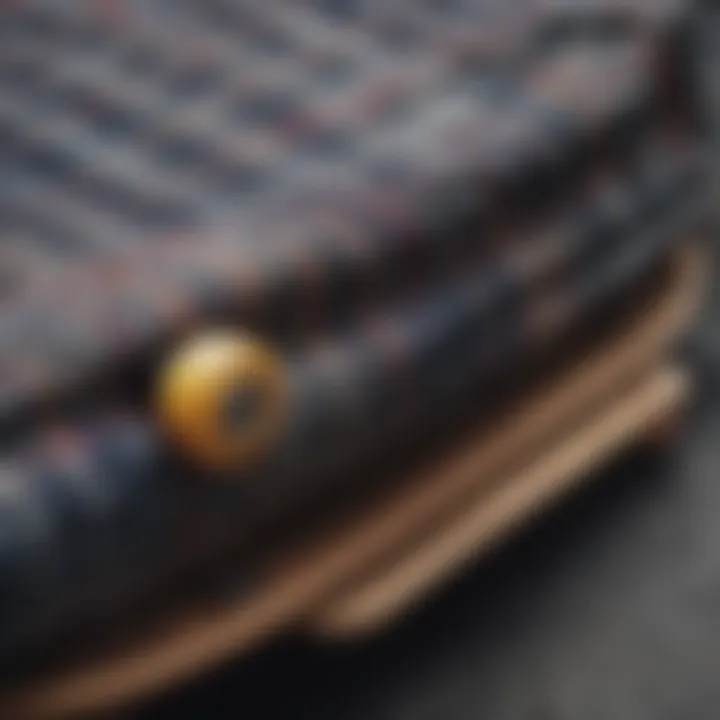 A close-up of a flannel shirt draped over a skateboard, showcasing its texture and pattern.