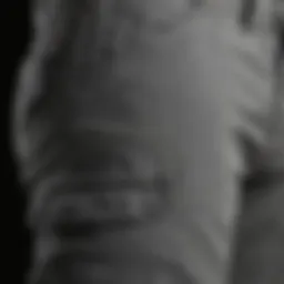 A close-up of grey skinny cargo pants showcasing their material and stitching.